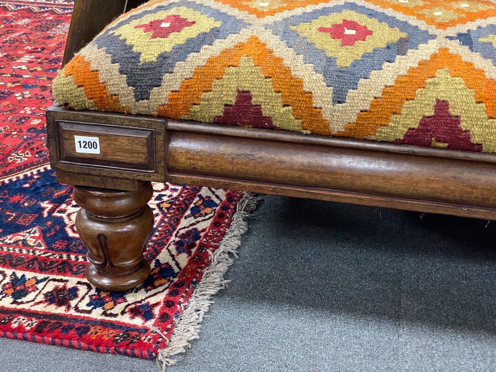 A William IV mahogany stool with polychrome kilim upholstered seat width 164cms, depth 59cms, height 36cms. (Adapted).